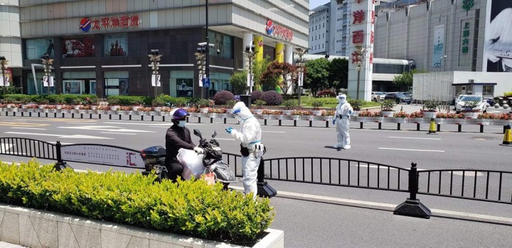 上海市内のようす。防護服を着ているのは区居民委員会のスタッフやボランティア