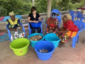 フェルト雑貨の作り方を学ぶ研修で、洗った羊毛のごみをケニア人の母親たちと一緒に取り払っているところ。左から2人目が三関理沙さん